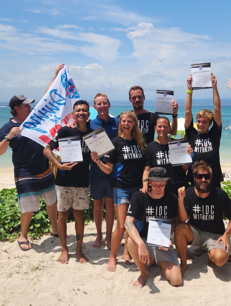 A group of excited IDC candidates proudly show off their PADI certifications after completing their training at Scuba Center Asia Lembongan. Their smiles reflect the satisfaction and accomplishment they feel after their hard work.